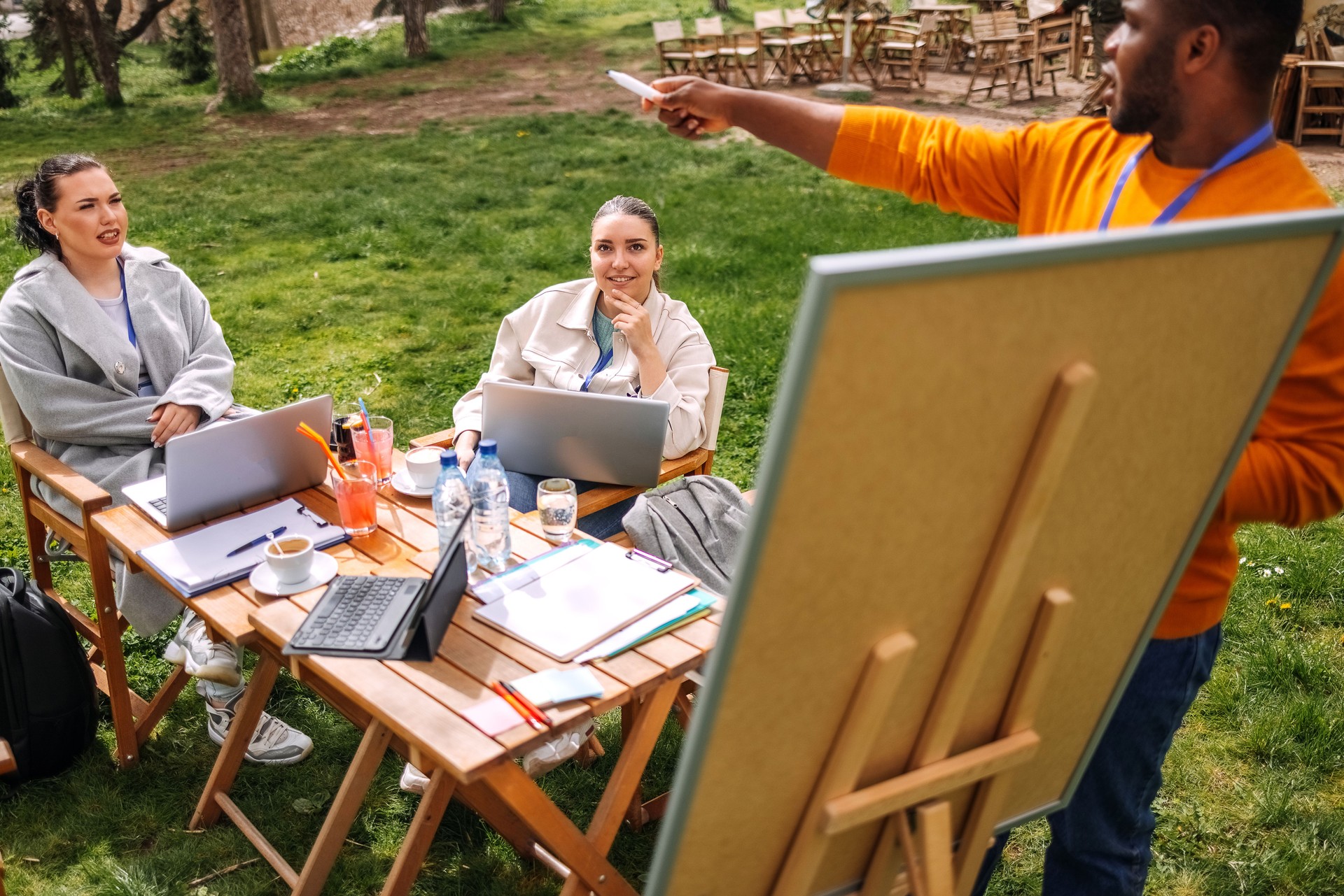 Group of employees having outdoor business meeting