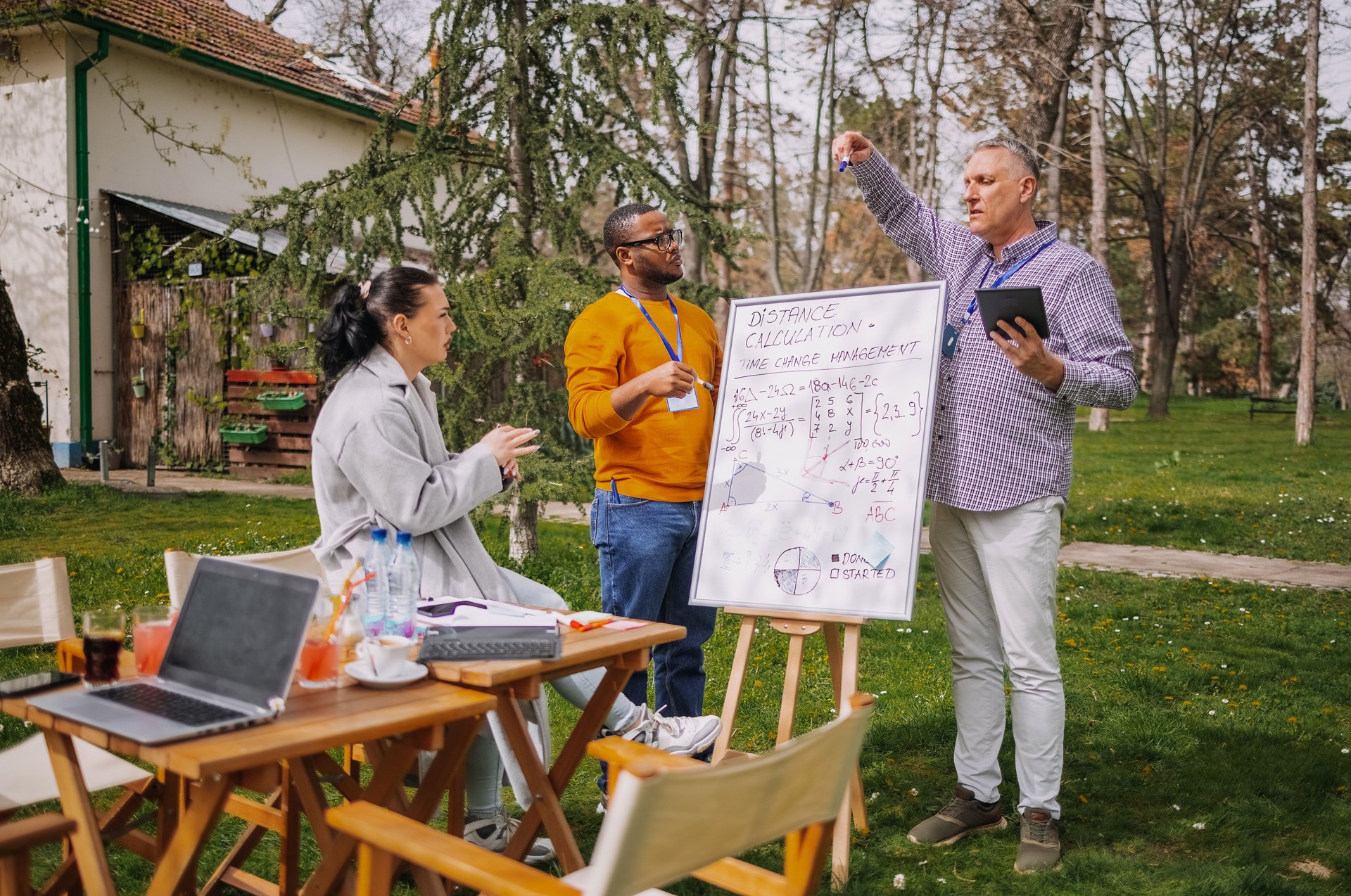 Group of employees having outdoor business meeting