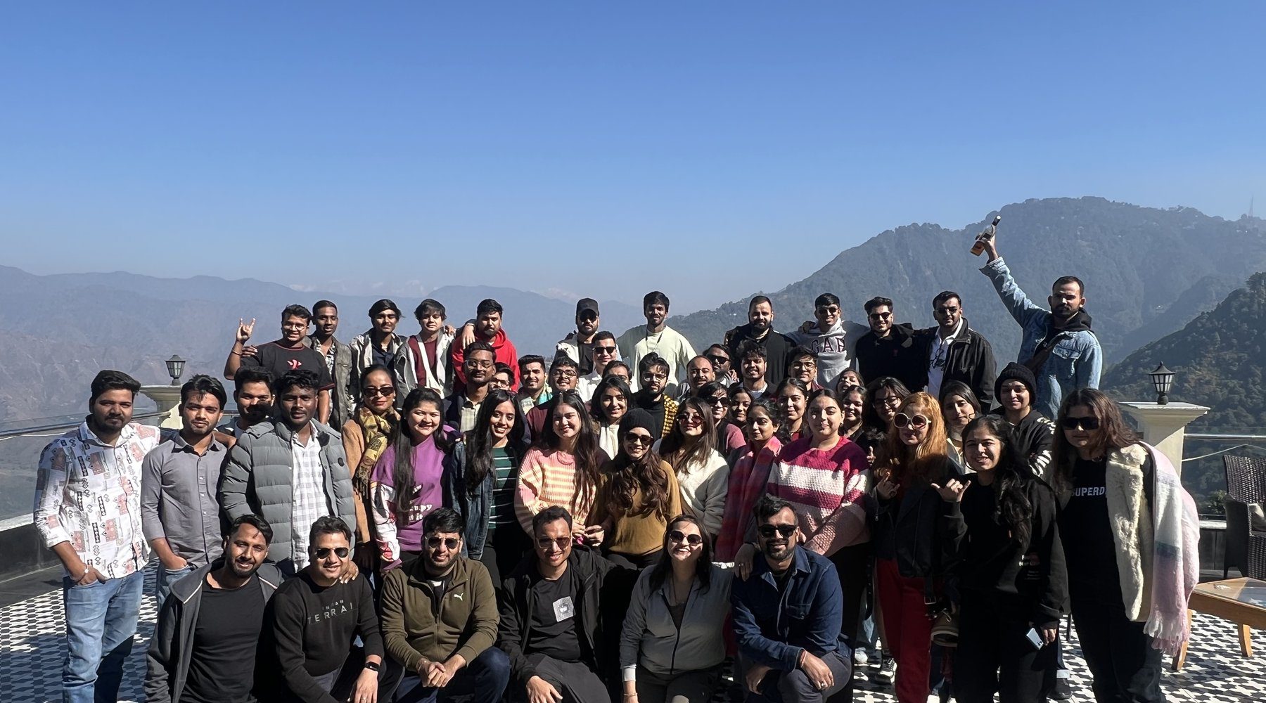 Gotag corporate offsite group photo on rooftop terrace with Himalayan mountain views