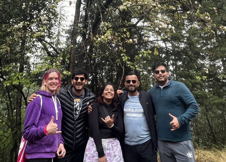 Corporate team trekking under blossom trees organised by Gotag